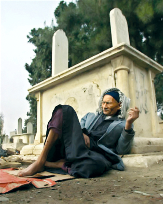 "احد السكان يستريح جوار مقبرة"