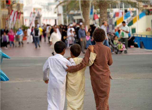 "صحبة من الابناء الاصدقاء الثلاث يتهامسون سويا لتحديد موقع البهجة القادمة في اروقة القرية العالمية التي جذبتهم بما تقدمه وجعلتهم رجال صغار يتبادلون حديث الكبار في قريتهم العالمية"