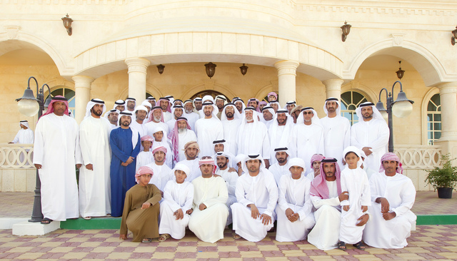 "محمد بن زايد في لقطة تذكارية متوسطا مضيفيه من أسرة الشامسي \t\t\t\t\t\t  من المصدر"