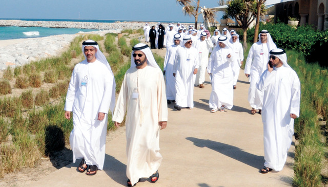 "محمد بن راشد في طريقه لغرس أول شجرة قرم «المانجروف الأحمر» يرافقه حمدان بن راشد وسيف بن زايد والوزراء"