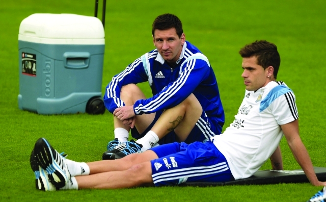"Argentina's forward Lionel Messi and midfielder Fernando Gago (R) attend a training session at the Cidade do Galo base camp in Vespasiano near Belo Horizonte during the 2014 FIFA World Cup on July 2, 2014. AFP PHOTO / JUAN MABROMATA"