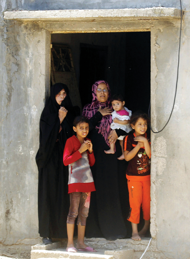 "عائلة فلسطينية تراقب تشييع شهيد اغتاله الاحتلال في غارة على خان يونس                        أ.ف.ب"