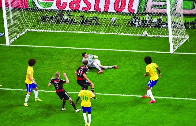 "Germany's Andre Schuerrle, second left, scores his side's 6th goal during the World Cup semifinal soccer match between Brazil and Germany at the Mineirao Stadium in Belo Horizonte, Brazil, Tuesday, July 8, 2014. (AP Photo/Francois Xavier Marit, Pool)"