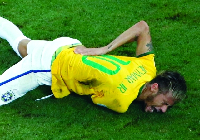 "Brazil's Neymar grimaces in pain after a challenge by Colombia's Camilo Zuniga during their 2014 World Cup quarter-final match at the Castelao arena in Fortaleza July 4, 2014. Neymar has been ruled out of the remainder of the World Cup after suffering a fractured vertebrae in their quarter-final win over Colombia on Friday, the team doctor said. REUTERS/Fabrizio Bensch (BRAZIL - Tags: SPORT SOCCER WORLD CUP)"