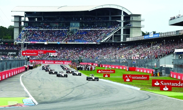 "Spectators watch the German Formula One Grand Prix at the Hockenheimring racing circuit in Hockenheim, southern Germany, on July 20, 2014. Mercedes-AMG's German driver Nico Rosberg won the competition, Williams' Finnish driver Valterri Bottas placed second and Mercedes-AMG's British driver Lewis Hamilton placed third. AFP PHOTO / PATRIK STOLLARZ"