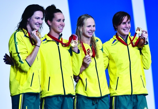 "(L-R) Gold medallists Australia's Cate Campbell, Australia's Emma McKeon, Australia's Bronte Campbell and Australia's Melanie Schlanger pose during the Women's 4x100m Freestyle Relay medals ceremony at the Tollcross International Swimming Centre during the 2014 Commonwealth Games in Glasgow on July 24, 2014. AFP PHOTO / ANDREJ ISAKOVIC"