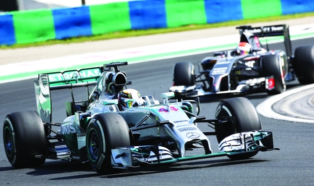 "Great Britain's Lewis Hamilton of Mercedes AMG Petronas F1 drives during the first practice session at the Hungaroring circuit in Budapest on ahead of the Hungarian Formula One Grand Prix on July 25, 2014. AFP PHOTO / FERENC ISZA"