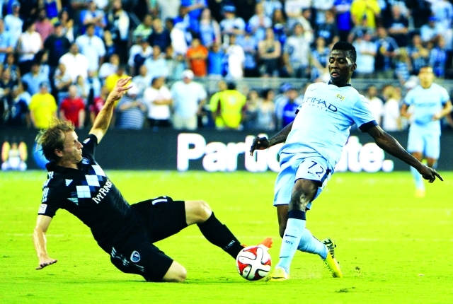 "Jul 23, 2014; Kansas City, KS, USA; Sporting KC defender Seth Sinovic (15) defends against Manchester City forward Kelechi Iheanacho (72) in the first half at Sporting Park. Manchester City won 4-1. Mandatory Credit: John Rieger-USA TODAY Sports"