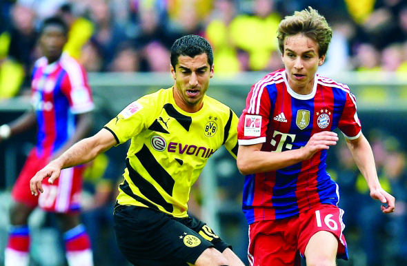 "Dortmund's Armenian midfielder Henrikh Mkhitaryan and Bayern Munich's midfielder Gianluca Gaudino (R) vie for the ball vie during the German Supercup football match Borussia Dortmund vs Bayern Munich in the German city of Dortmund on August 13, 2014. AFP PHOTO / PATRIK STOLLARZ DFL RULES TO LIMIT THE ONLINE USAGE DURING MATCH TIME TO 15 PICTURES PER MATCH. IMAGE SEQUENCES TO SIMULATE VIDEO IS NOT ALLOWED AT ANY TIME. FOR FURTHER QUERIES PLEASE CONTACT DFL DIRECTLY AT + 49 69 650050."