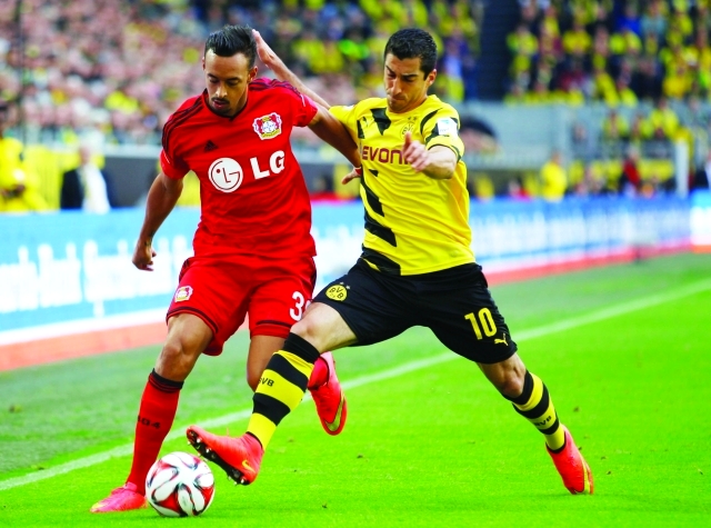 "Borussia Dortmund's Henrikh Mkhitaryan (R) challenges Bayer Leverkusen's Karim Bellerabi during the German first division Bundesliga soccer match in Dortmund August 23, 2014. REUTERS/Ina Fassbender (GERMANY - Tags: SPORT SOCCER) DFL RULES TO LIMIT THE ONLINE USAGE DURING MATCH TIME TO 15 PICTURES PER GAME. IMAGE SEQUENCES TO SIMULATE VIDEO IS NOT ALLOWED AT ANY TIME. FOR FURTHER QUERIES PLEASE CONTACT DFL DIRECTLY AT + 49 69 650050"