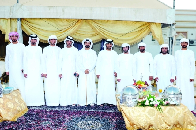 "العريس سعيد مع عدد من الأصدقاء"