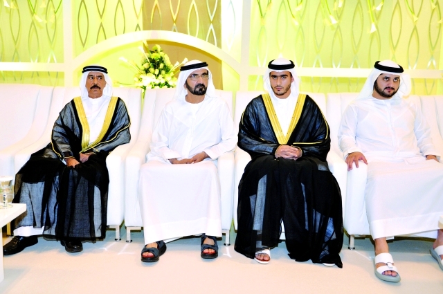 "نائب رئيس الدولة ومكتوم بن محمد والعريس ووالده خلال الحفل"