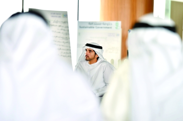 ".. وسموه يستمع لإحدى المشاركات خلال الورش الإبداعية"