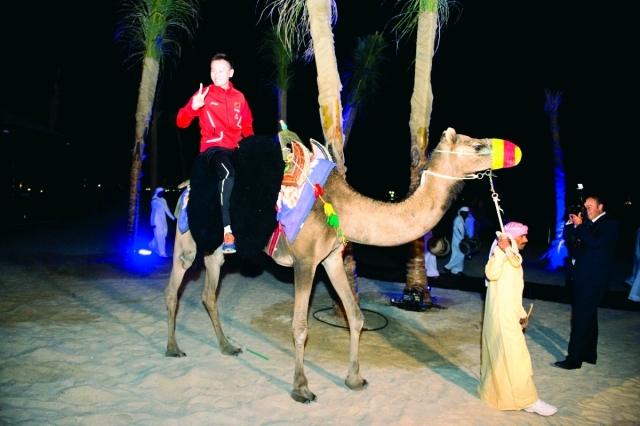 "اللاعب الصيني تشين سعيداً بركوب الجمل"