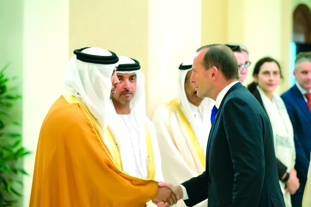 "رئيس الوزراء الأسترالي مصافحاً منصور بن زايد بحضور هزاع بن زايد"