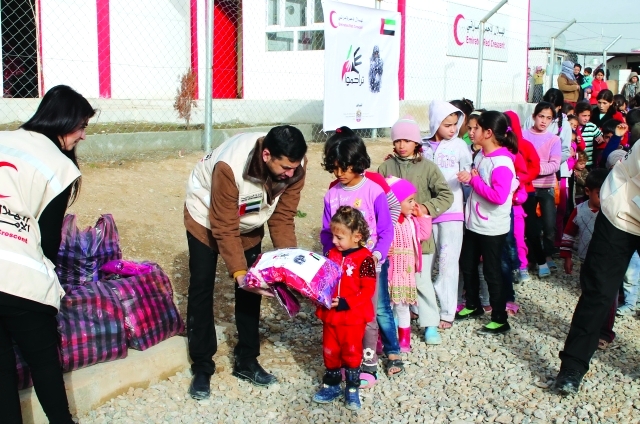 "وخلال التوزيع على أطفال  اللاجئين"