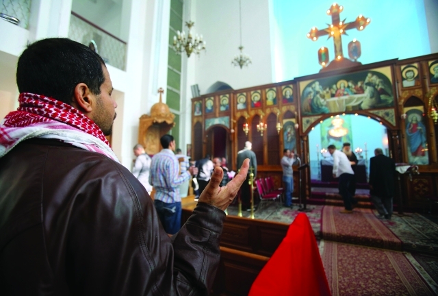 ".. وقدّاس في إحدى الكنائس - أ.ف.ب"