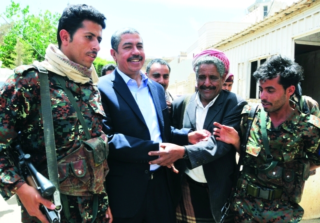 "بحاح محاطاً بعدد من المسلّحين بعد الإفراج عنه في صنعاء أ.ف.ب"