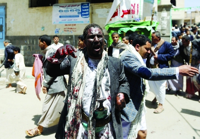 ".. ورجل مدمى بعد نجاته من التفجيرات - رويترز"