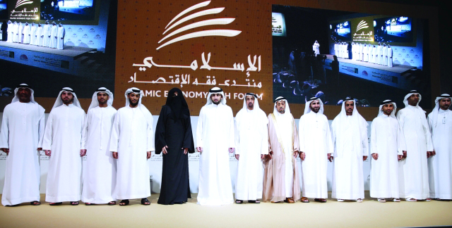 "أحمد بن محمد يتوسط أعضاء اللجنة العليا المنظمة لمنتدى فقه الاقتصاد الإسلامي بحضور حمد الشيباني تصوير: خليفة اليوسف"