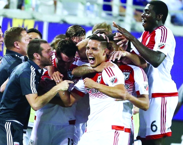 "D.C. United's Luis Silva, center, celebrates with teammates after he scored the winning goal during an MLS soccer match against Orlando City, Friday, April 3, 2015 in Orlando, Fla. (AP Photo/Orlando Sentinel, Stephen M. Dowell) MAGS OUT; NO SALES"