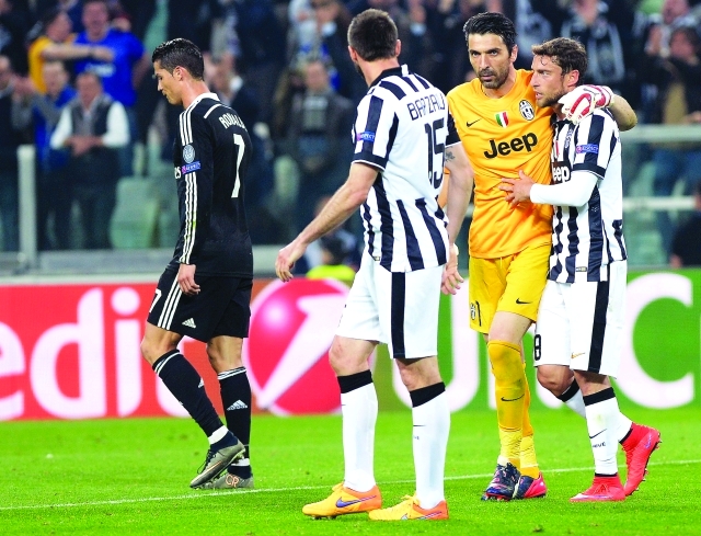 "Juventus goalie Gianluigi Buffon hugs teammate Claudio Marchisio as Real Madrid's Cristiano Ronaldo, left, walks by, at the end of the Champions League, semifinal soccer match between Juventus and Real Madrid at the Juventus Stadium in Turin, Italy, Tuesday, May 5, 2015. Juventus won 2-1. (AP Photo/Massimo Pinca)"