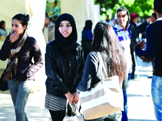 "TO GO WITH AFP STORY BY MOUNIR SOUISSI Tunisian students chat on Habib Bourguiba Avenue in Tunis on November 14, 2014. Tunisia has now more than 600,000 unemployed (15 percent of the working age population), of which about 240,000 are graduates from higher education institutions, according to official statistics. AFP PHOTO / FETHI BELAID"