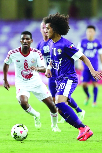 "Al Ain’s Soccer player Omer Abdulrahman battles for the ball with player of Sharjah during their Arabian Gulf League Match between Al Ain Vs Sharjah in Hazza Bin Zayed Stadium Al Ain on May,09,2015 photo by Nasser Babu"