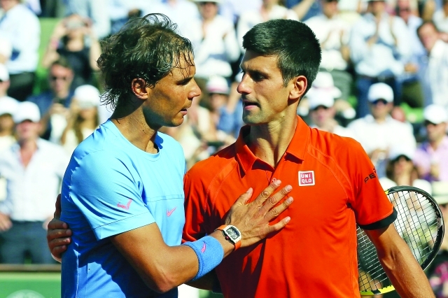 "Serbia's Novak Djokovic hugs Spain's Rafael Nadal, left, after winning the quarterfinal match of the French Open tennis tournament in three sets, 7-5, 6-3, 6-1, at the Roland Garros stadium, in Paris, France, Wednesday, June 3, 2015. (AP Photo/David Vincent)"
