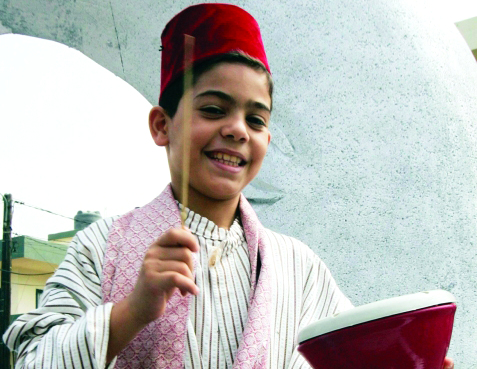 "A Lebanese orphan plays an instrument during a tour in the south of Beirut August 23, 2008. The tour, which was organised by the Islamic Orphans House, was meant to drum up funding for the orphans during Ramadan, when donations of food and money are recognised as acts of goodwill. Clerics predict Ramadan will begin on September 1, depending on the first sighting of the new moon. REUTERS/Sharif Karim (LEBANON)"