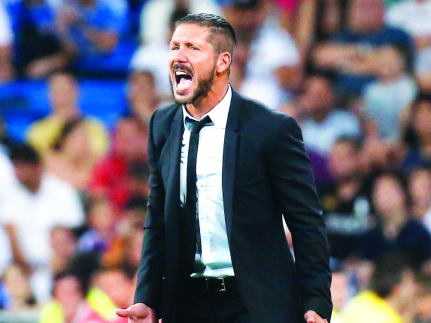 "Atletico Madrid's coach Diego Simeone reacts during their Spanish Super Cup first leg soccer match against Real Madrid at the Santiago Bernabeu stadium in Madrid August 19, 2014. REUTERS/Juan Medina (SPAIN - Tags: SPORT SOCCER)"