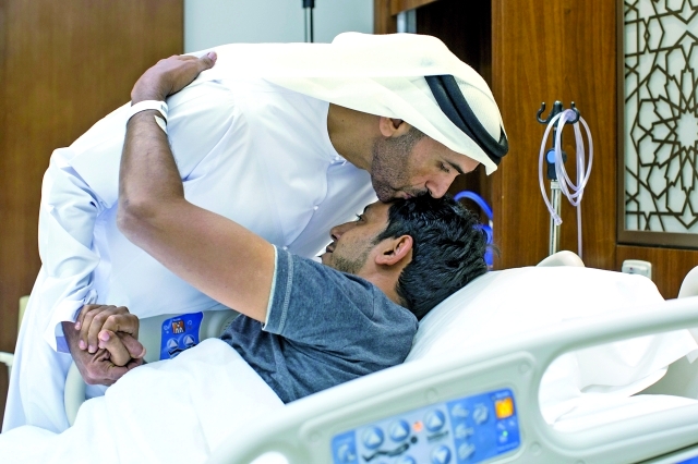 "■ نهيان بن زايد مقبلاً جبين أحد الجرحى"