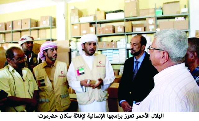 "■ متطوعون من الهلال الأحمر في حديث مع مجموعة من سكان حضرموت | وام"