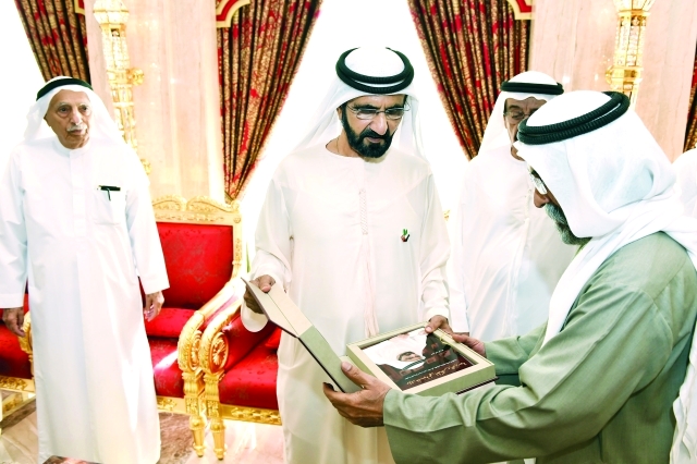 "■ محمد بن راشد يتسلم نسخة الكتاب من علي أبو الريش بحضور محمد النابودة وجمعة الماجد | تصوير: محمد هشام"