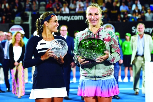 "epa05102939 Svetlana Kuznetsova (R) of Russia and Monica Puig (L) of Puerto Rico pose for photographs with their winner and runner up trophies at the Sydney International Tennis Tournament, in Sydney, Australia, 15 January 2016. EPA/DAN HIMBRECHTS AUSTRALIA AND NEW ZEALAND OUT"