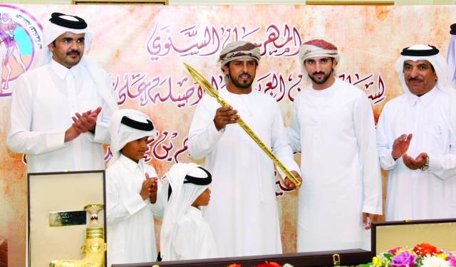"■ حمدان بن محمد لدى تتويجه الفائزين بالرموز بحضور جوعان بن حمد وحمد بن جاسم | البيان"