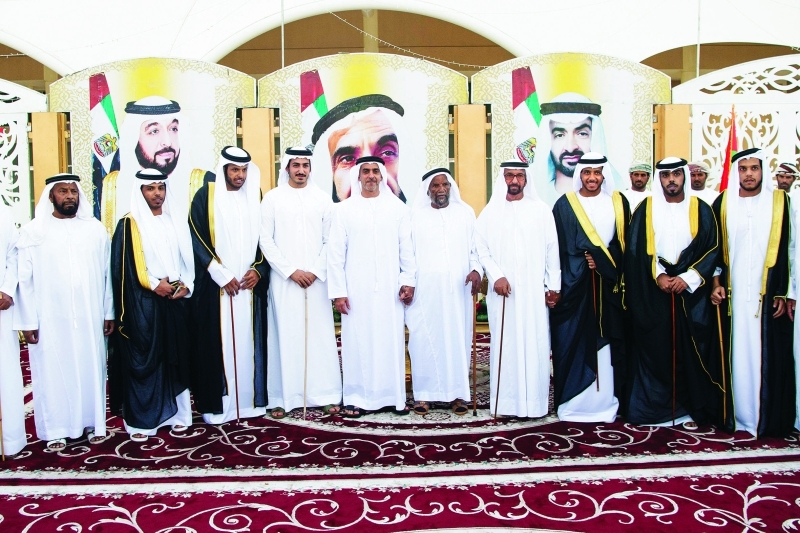 "■ سيف بن زايد مع العريس والحضور"
