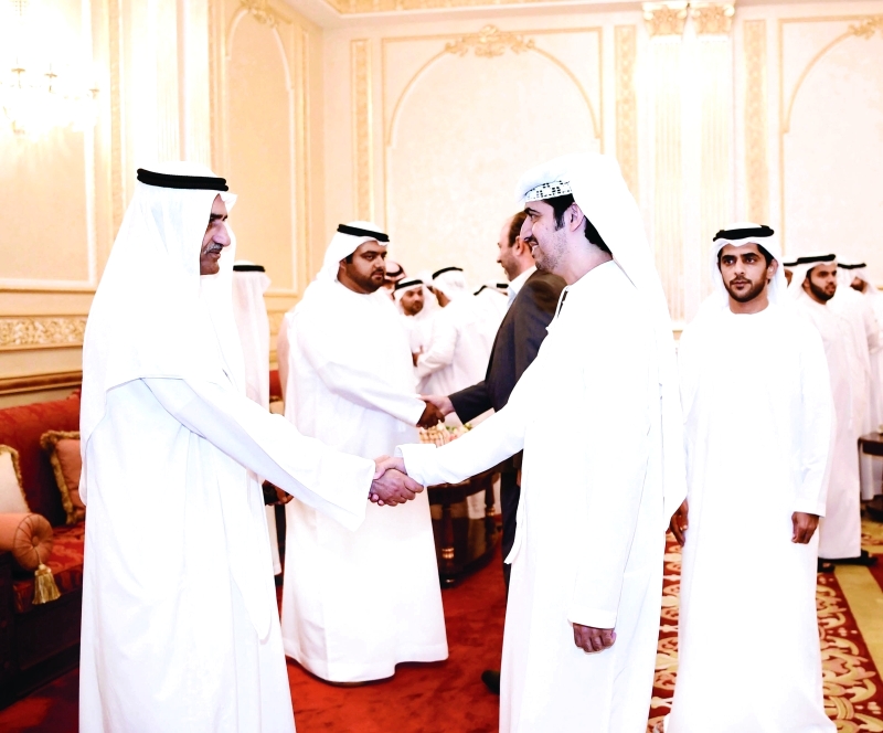"■حمد الشرقي مستقبلاً المهنئين بحضور محمد بن حمد"