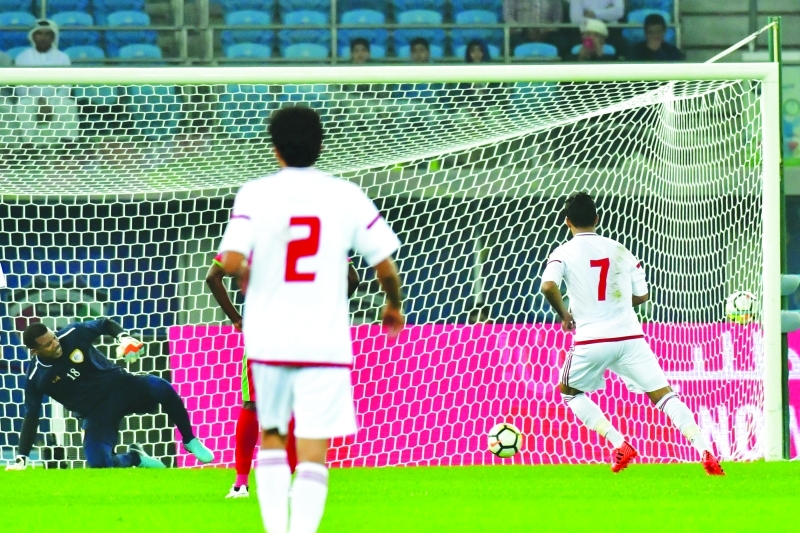 "Emirates' Ali Mabkhout (R) converts a penalty to give his team the lead during their 2017 Gulf Cup of Nations football match between UAE and Oman at the Sheikh Jaber al-Ahmad Stadium in Kuwait City on December 22, 2017. / AFP / GIUSEPPE CACACE"