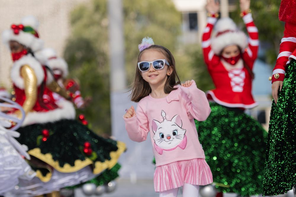 "DUBAI, 14 December 2021. A Child seen dancing with Christmas parade performers at Expo 2020, Expo 2020 Dubai. (Photo by Antony Fleyhan /Expo 2020 Dubai)"