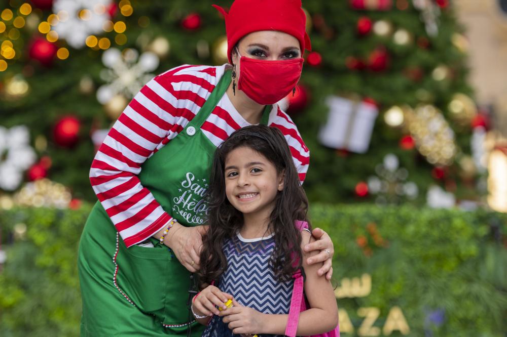 "DUBAI, 14 December 2021. A child with Santa’s helpers at Expo 2020, Expo 2020 Dubai. (Photo by Antony Fleyhan /Expo 2020 Dubai)"