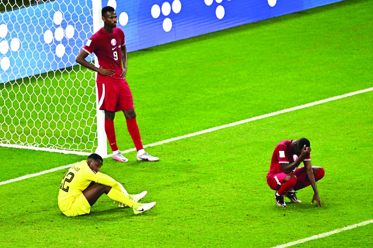"TOPSHOT - Players react after the final whistle of the Qatar 2022 World Cup Group A football match between Qatar and Senegal at the Al-Thumama Stadium in Doha on November 25, 2022. (Photo by MANAN VATSYAYANA / AFP)"