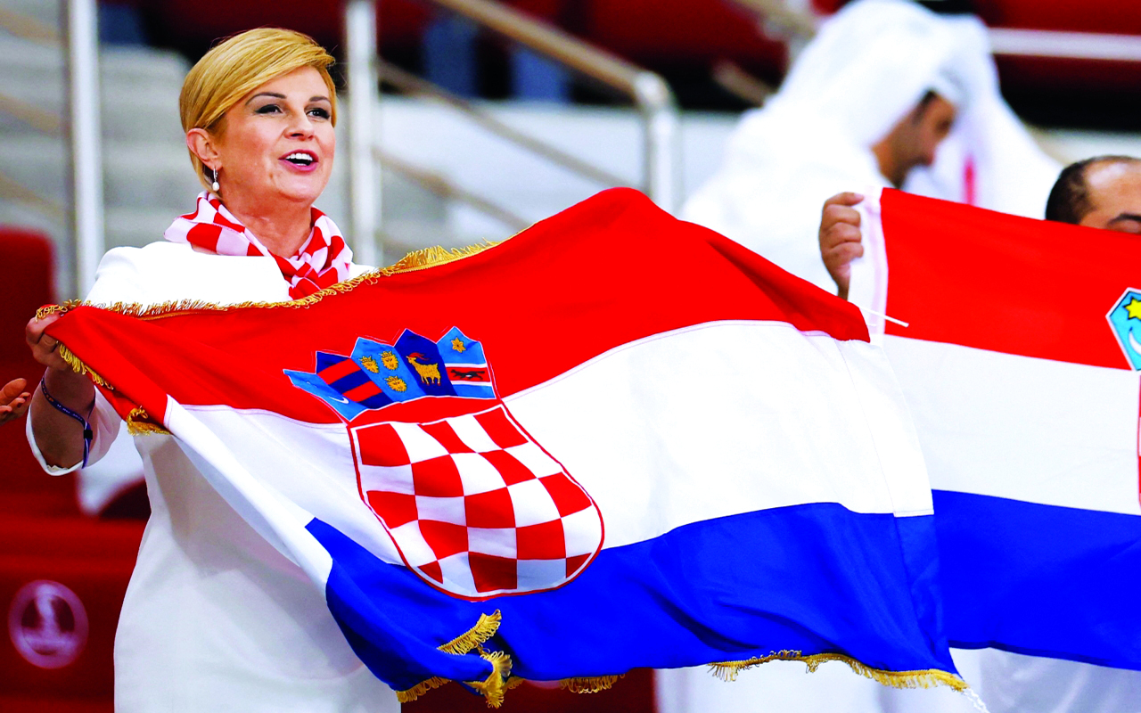 "Croatian former president Kolinda Grabar-Kitarovic celebrates after Croatia won the  Qatar 2022 World Cup third place play-off football match between Croatia and Morocco at Khalifa International Stadium in Doha on December 17, 2022. (Photo by Odd ANDERSEN / AFP)"