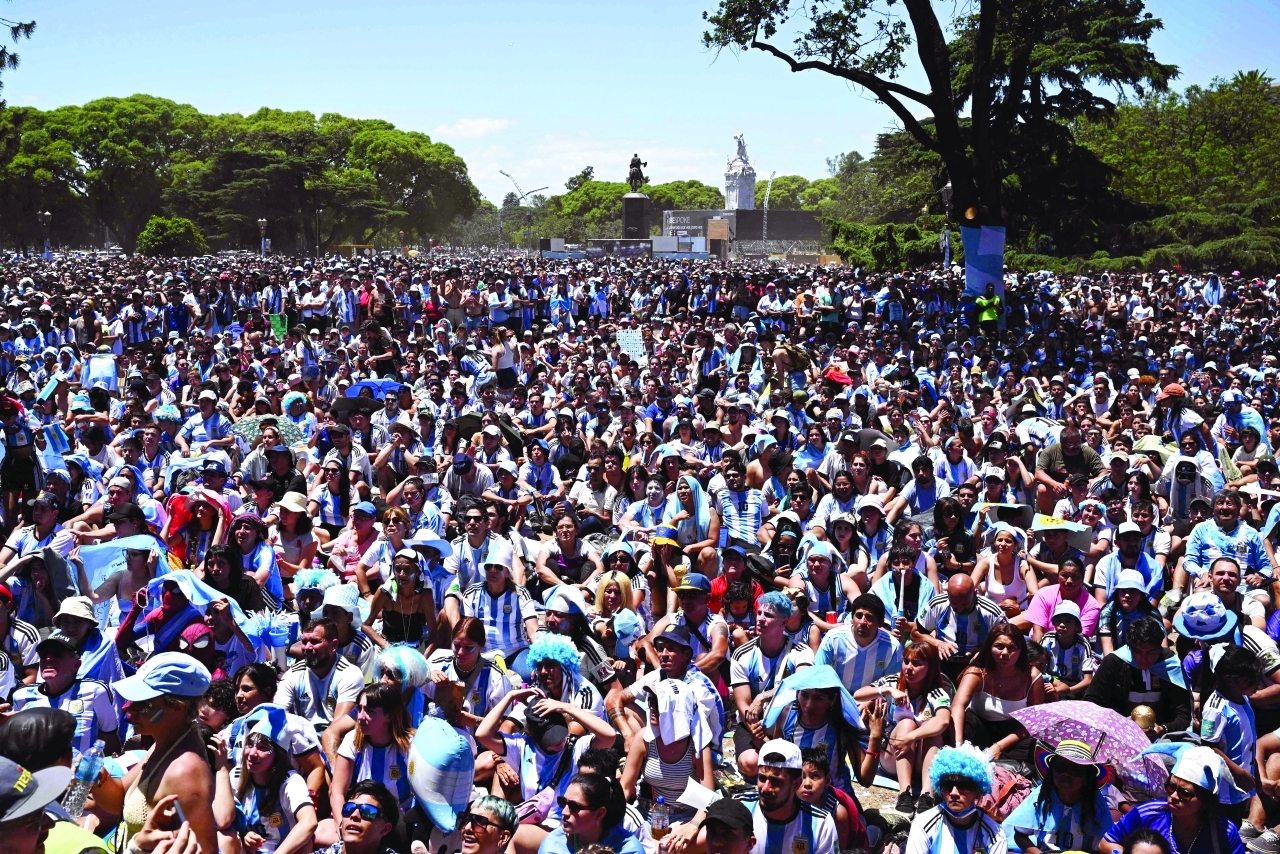 "Fans of Argentina react while watching the live broadcast of the Qatar 2022 World Cup final football match between Argentina and France in Buenos Aires, on December 18, 2022. (Photo by Luis ROBAYO / AFP)"