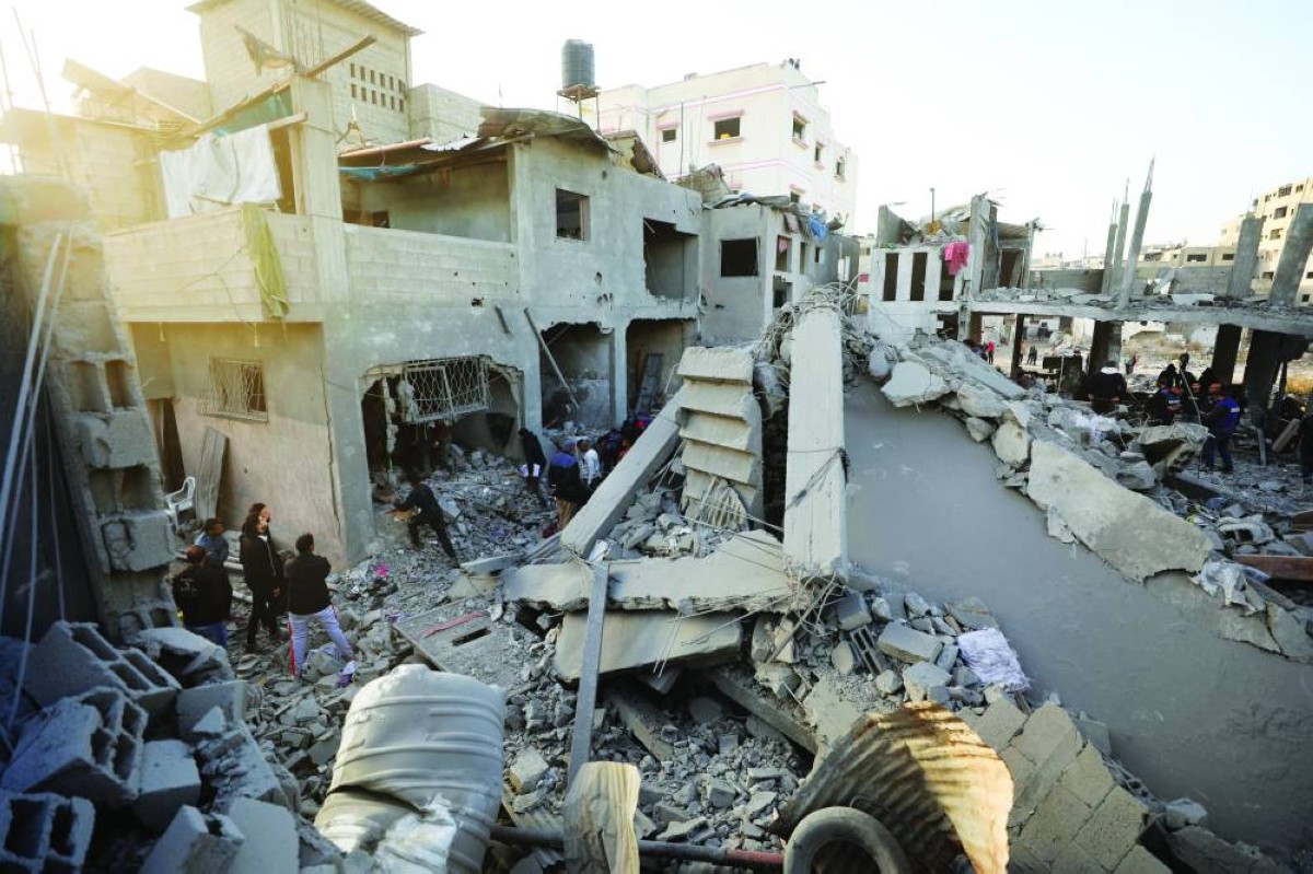 Palestinians inspect the site of an Israeli airstrike on a house, amid the ongoing conflict between Israel and Hamas, in Gaza City, December 27, 2024. REUTERS/Dawoud Abu Alkas