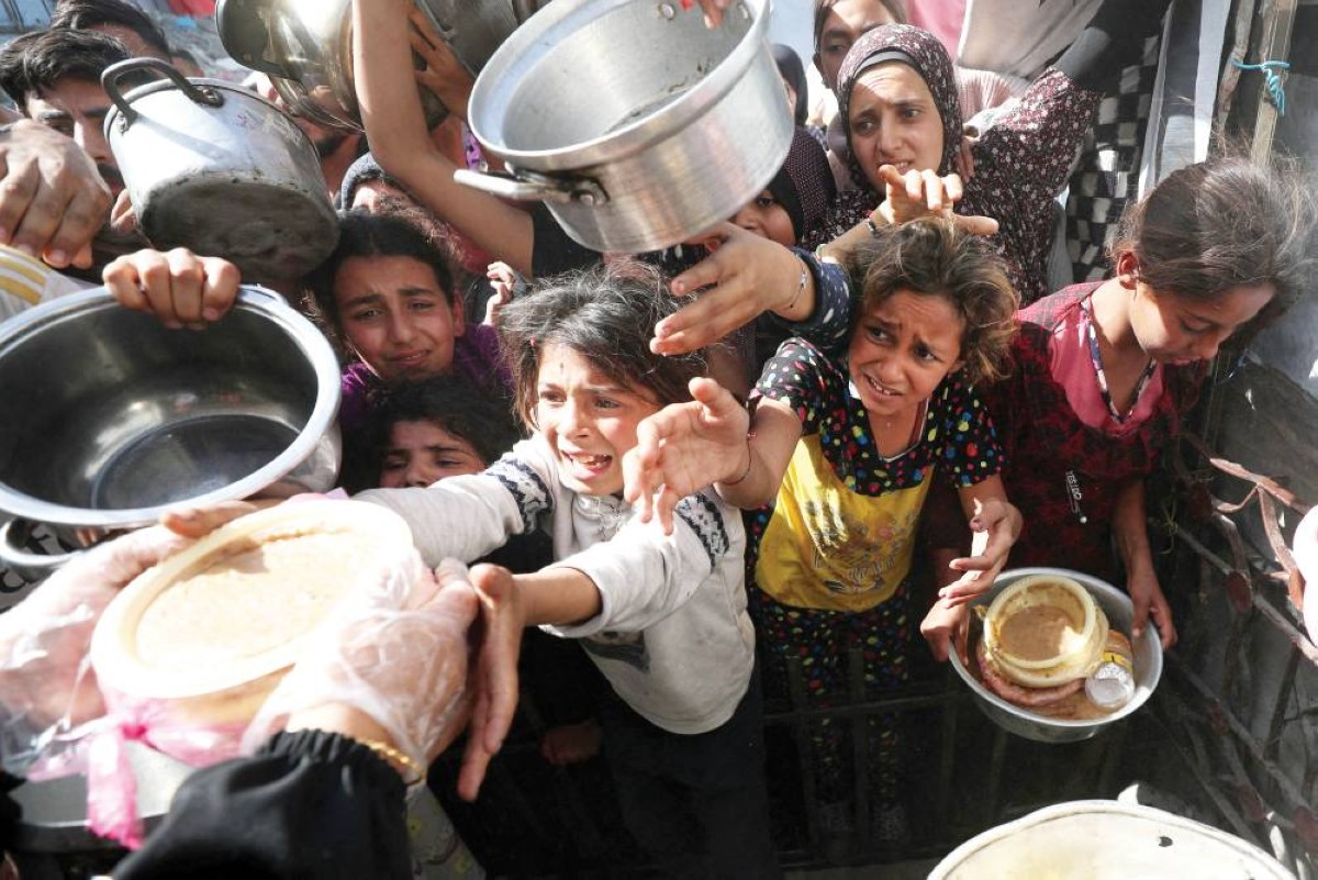 أطفال فلسطينيون ينتظرون الحصول على طعام في بيت لاهيا شمال قطاع غزة 