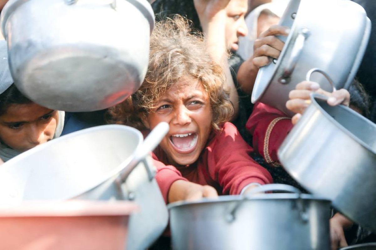 تدافع الفلسطينيين للحصول على طعام من أحد المطابخ الخيرية في خان يونس جنوب القطاع 