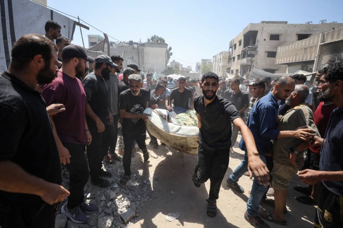 فلسطينيون خلال نقلهم ضحايا غارة إسرائيلية على مدينة غزة 