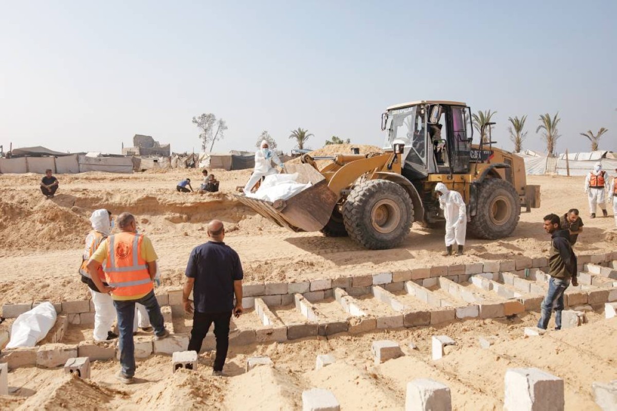 مشهد من دفن رفات وجثث فلسطينيين أعادتهم إسرائيل في مقبرة جماعية بدير البلح 


