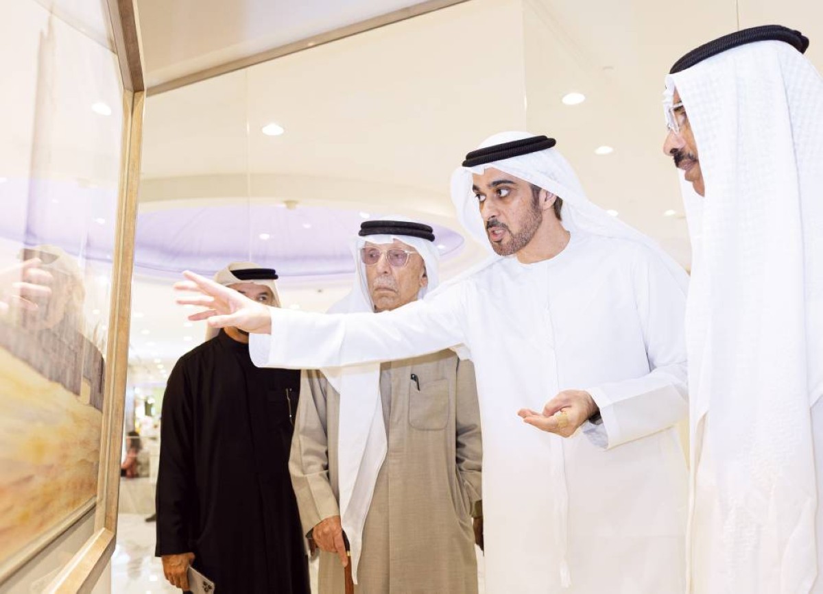 محمد المر وعبدالغفار حسين يستمعان من فريد الريس إلى شرح عن إحدى لوحاته